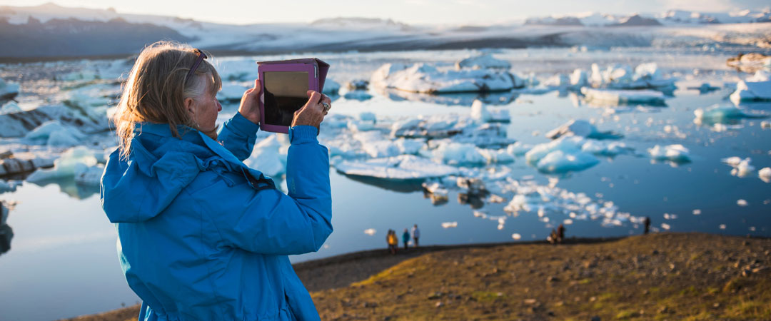 Woman taking photos in Iceland.
